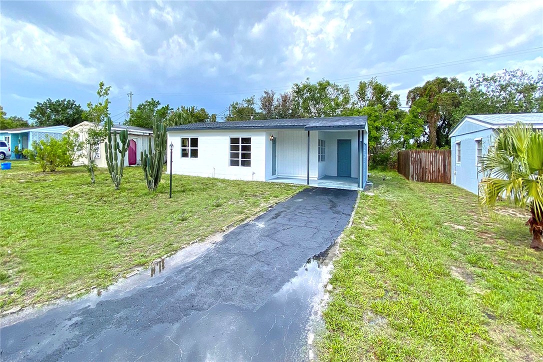 355 6th Road Southwest Vero Beach, FL 32962 - Photo 4 of 23 a front view of a house with a yard and trees