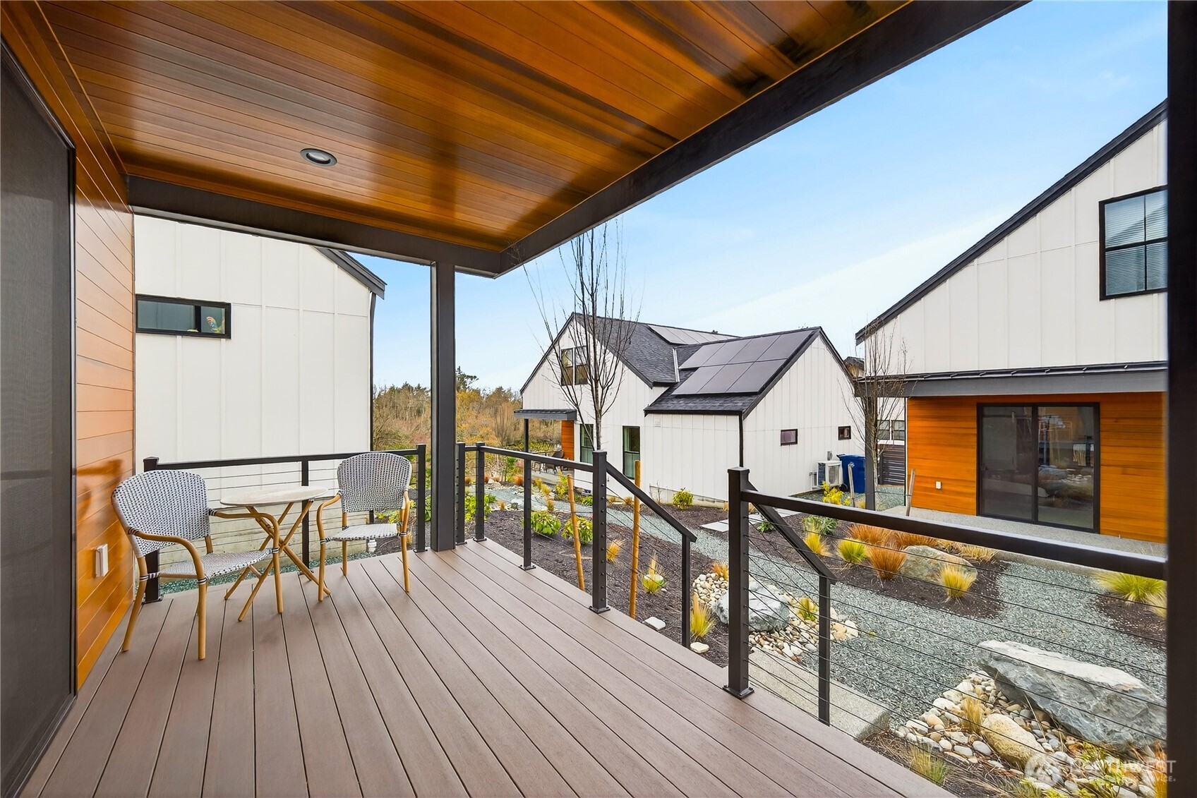 3908 Crosswinds Court Anacortes, WA 98221 - Photo 25 of 34 a view of a balcony with chairs and wooden floor