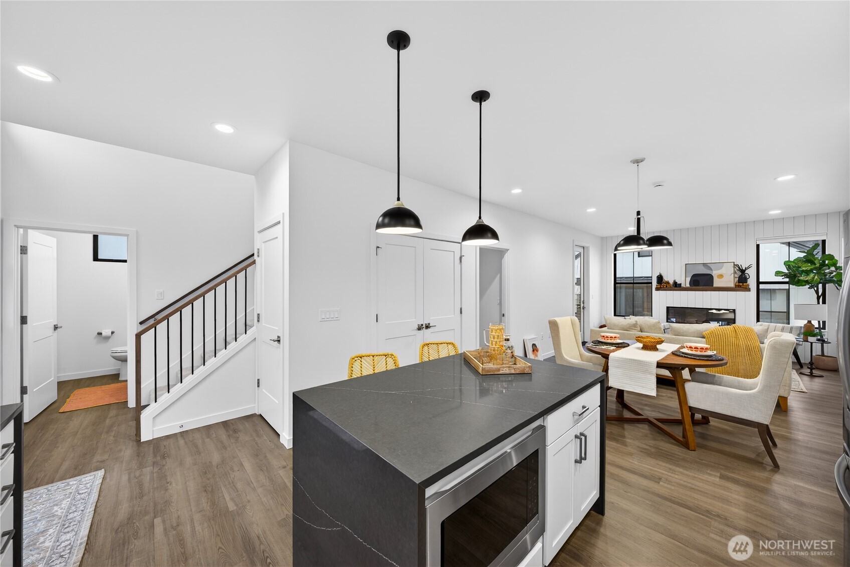 3908 Crosswinds Court Anacortes, WA 98221 - Photo 6 of 34 a kitchen with stainless steel appliances granite countertop a stove a sink and a wooden floor