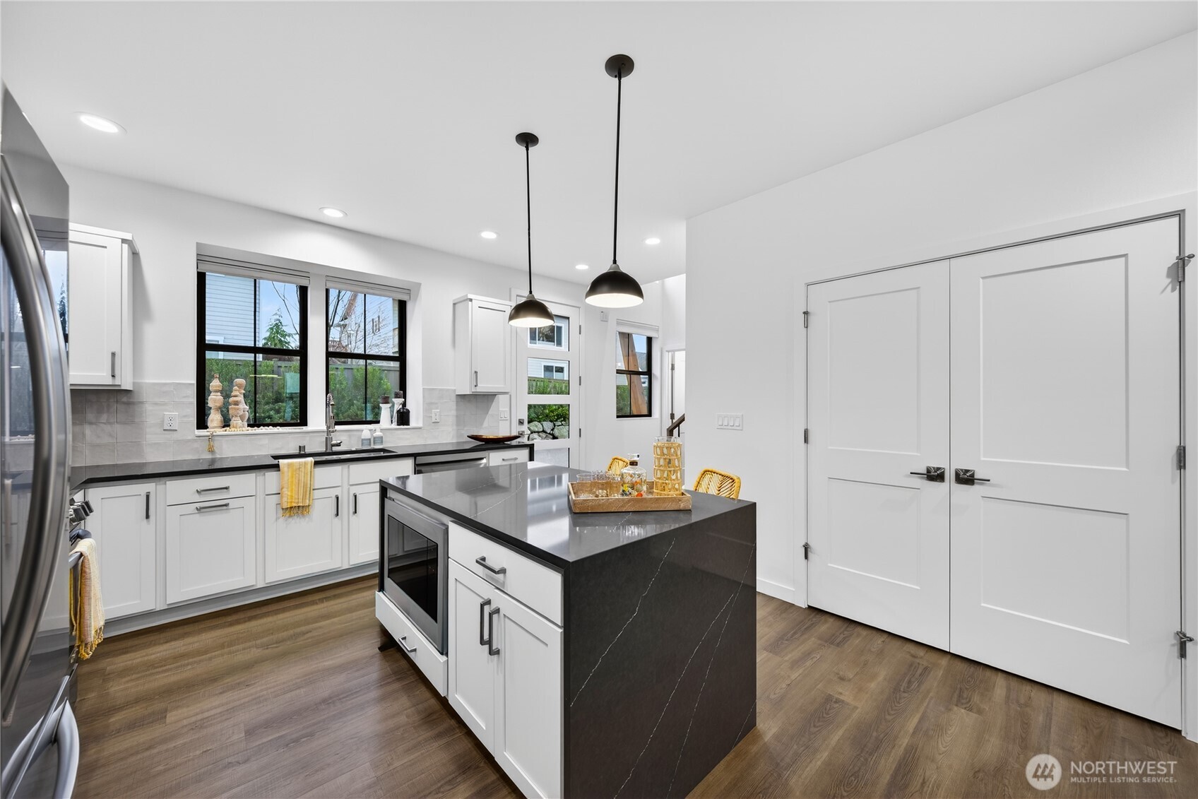 3908 Crosswinds Court Anacortes, WA 98221 - Photo 7 of 34 a kitchen with granite countertop a sink stove and cabinets