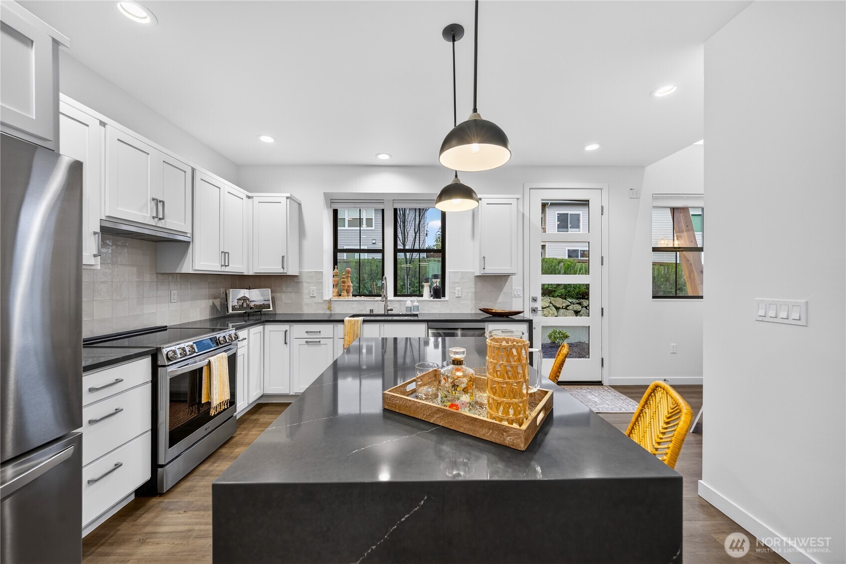 3908 Crosswinds Court Anacortes, WA 98221 - Photo 8 of 34 a kitchen with stainless steel appliances granite countertop a sink stove and refrigerator