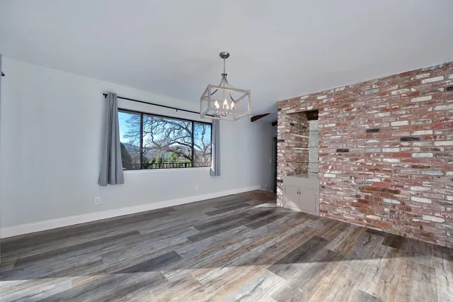 a kitchen with a sink cabinets and wooden floor