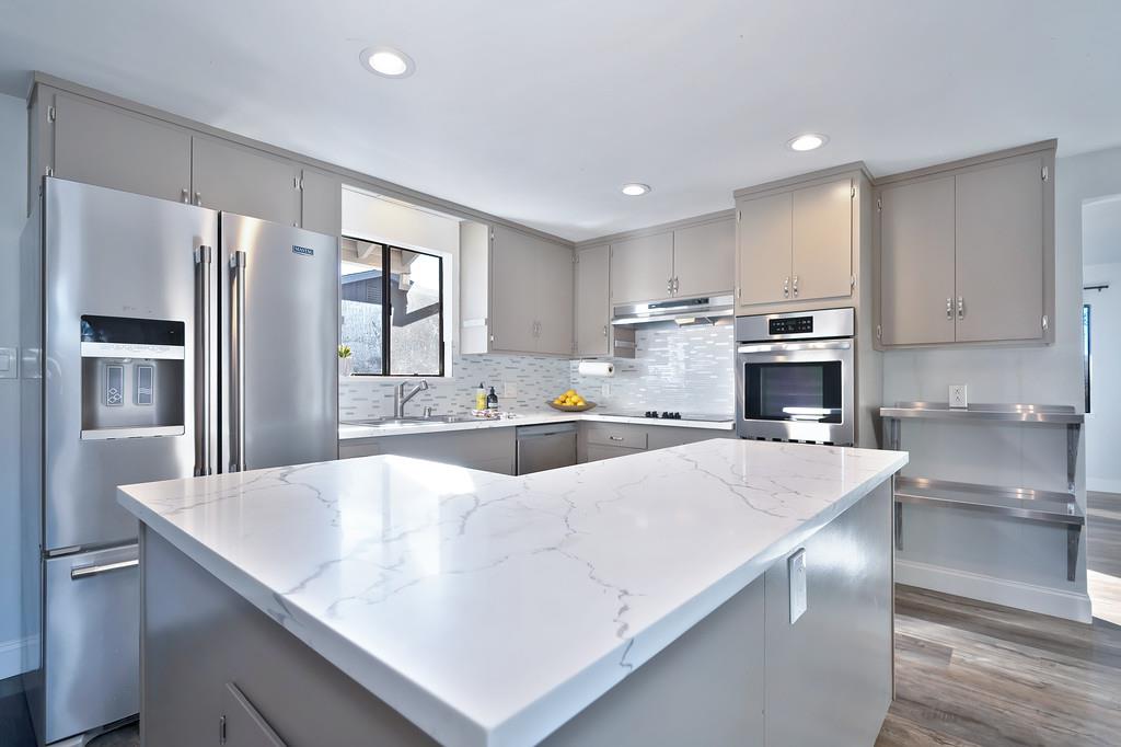 2298 Pinon Road Rescue, CA 95672 - Photo 24 of 67 a large kitchen with kitchen island a large counter top space a sink stainless steel appliances and cabinets