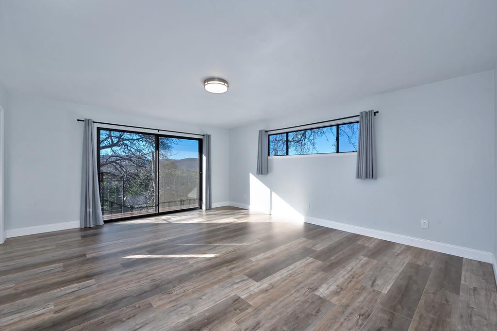 2298 Pinon Road Rescue, CA 95672 - Photo 34 of 67 a view of an empty room with wooden floor and a window