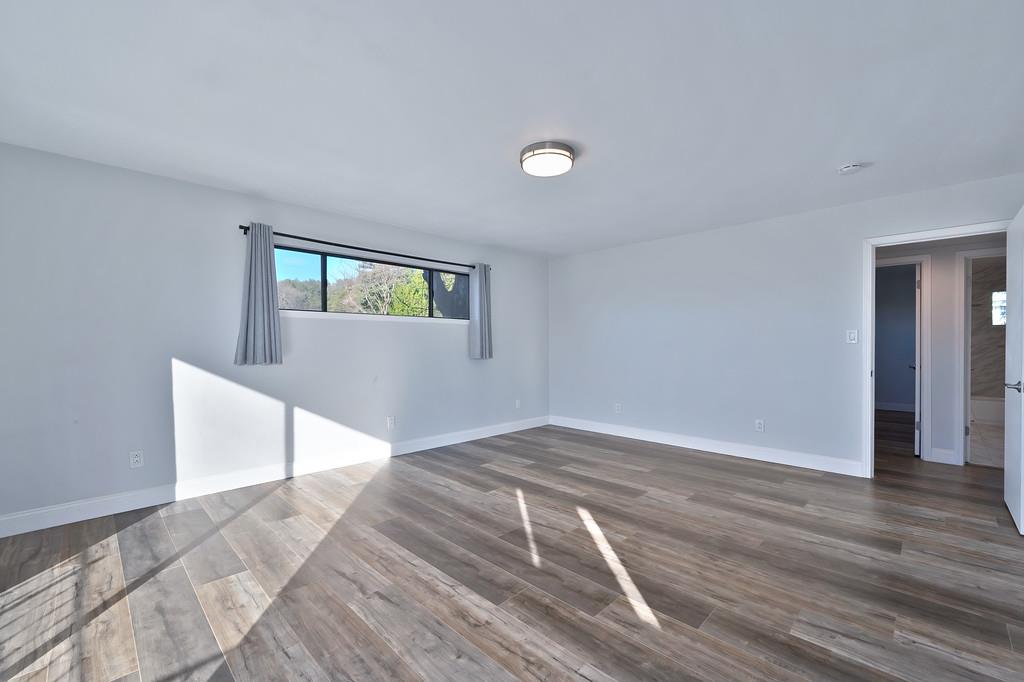 2298 Pinon Road Rescue, CA 95672 - Photo 37 of 67 a view of an empty room with wooden floor and a window