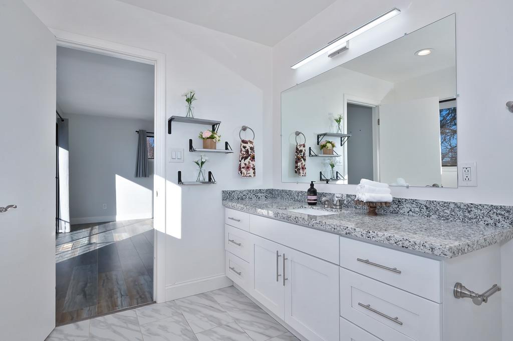 2298 Pinon Road Rescue, CA 95672 - Photo 40 of 67 a spacious bathroom with a granite countertop sink and a mirror