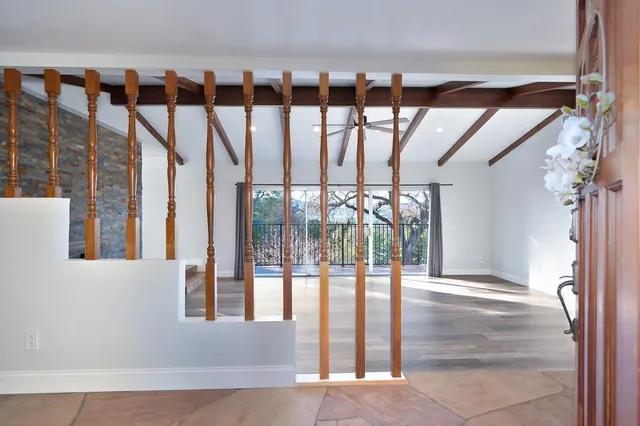 a view of empty room with wooden floor and fireplace