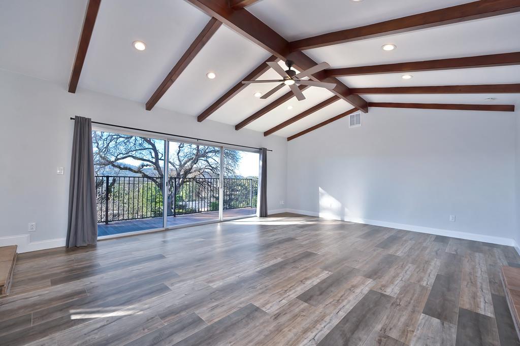 2298 Pinon Road Rescue, CA 95672 - Photo 9 of 67 a view of an empty room with wooden floor and a ceiling fan