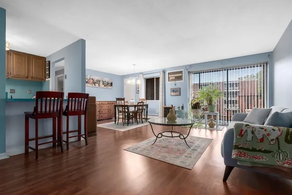 a living room with furniture and floor to ceiling windows