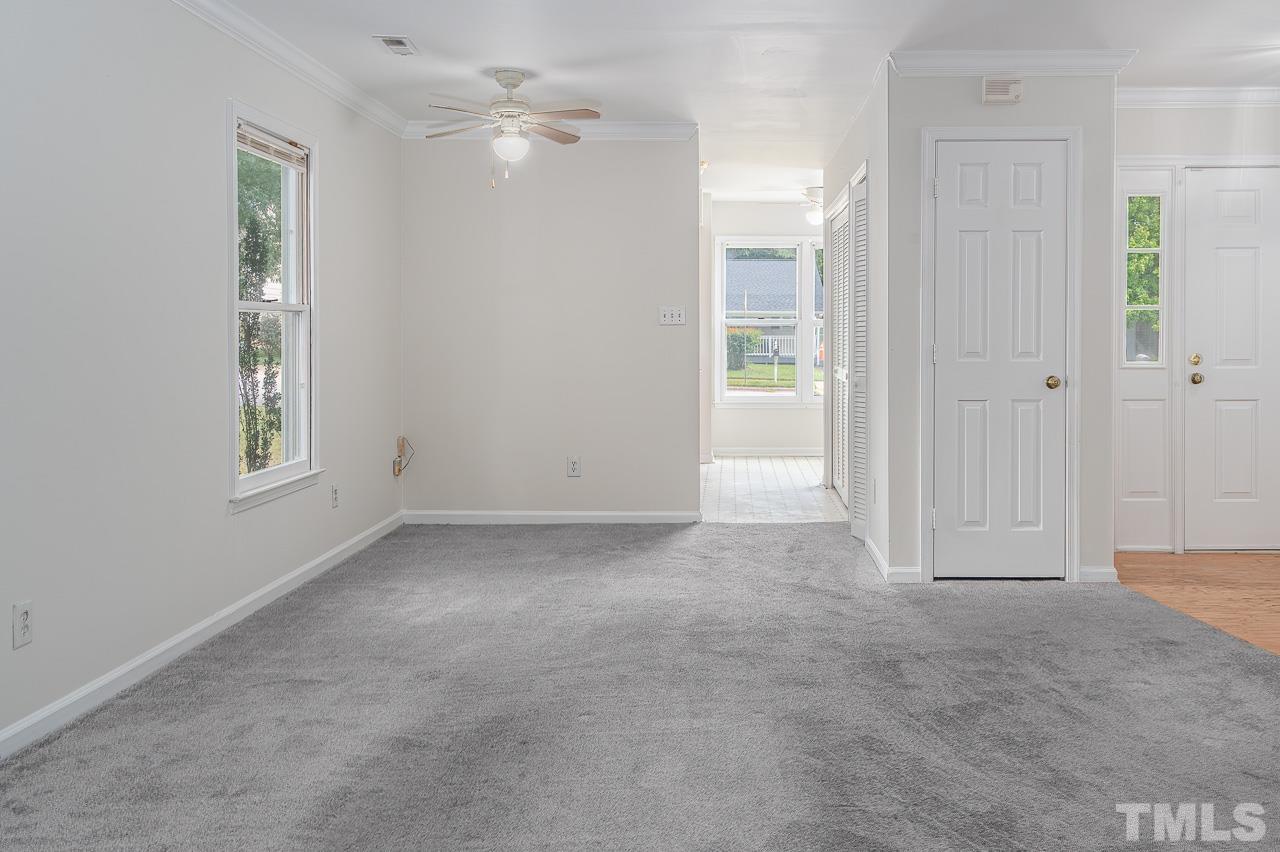 3120 Quinley Place Raleigh, NC 27604 - Photo 12 of 18 a view of a big room with windows and chandelier fan