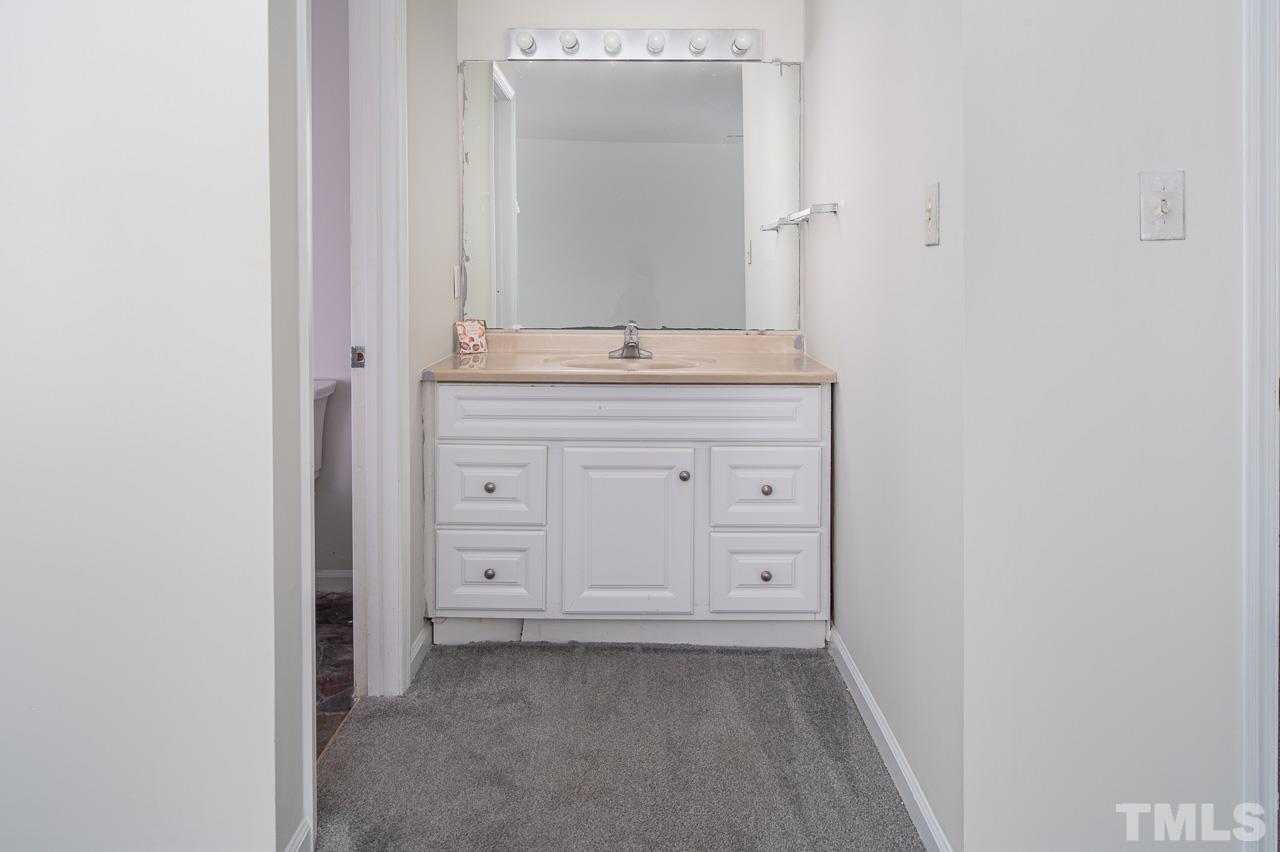 3120 Quinley Place Raleigh, NC 27604 - Photo 16 of 18 a bathroom with a granite countertop sink and a mirror
