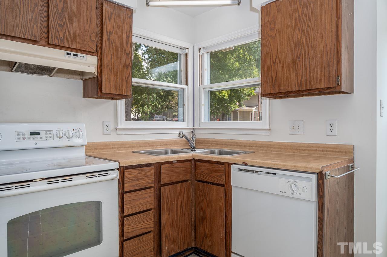 3120 Quinley Place Raleigh, NC 27604 - Photo 7 of 18 a kitchen with a sink stove and cabinets