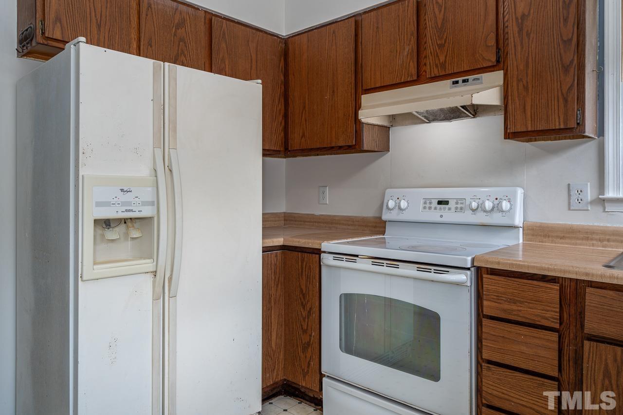 3120 Quinley Place Raleigh, NC 27604 - Photo 8 of 18 a kitchen with stainless steel appliances granite countertop a refrigerator and a stove