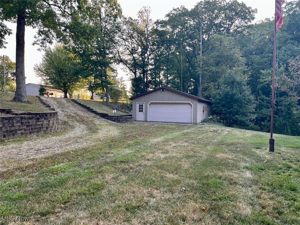 9366 Briar Road Magnolia, OH 44643 - Photo 22 of 25 View of grassy yard with an outbuilding and a garage