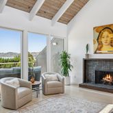 a living room with furniture fireplace and window
