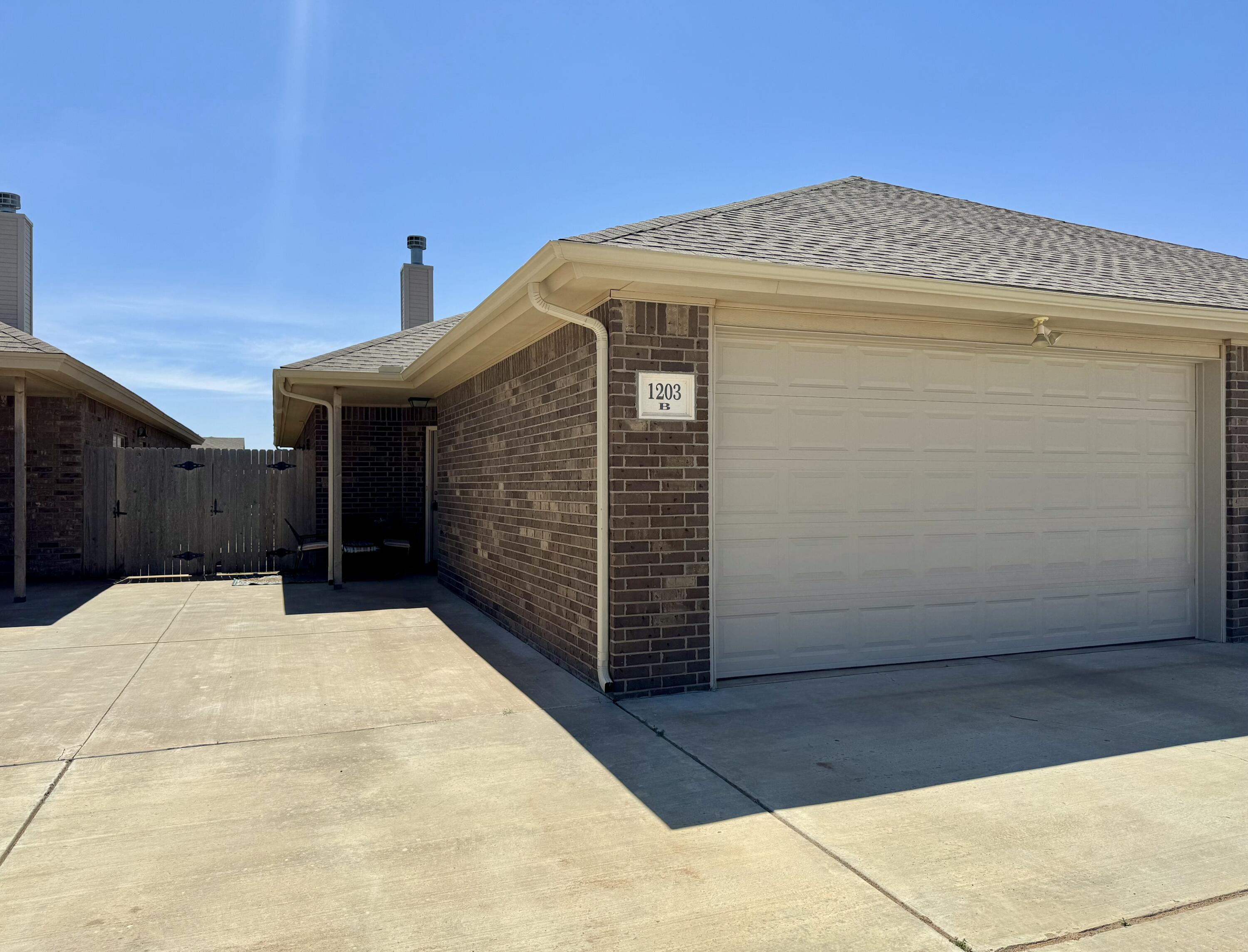 1203 Preston Trail, Unit B Wolfforth, TX 79382 - Photo 1 of 13 a view of a house with wooden fence