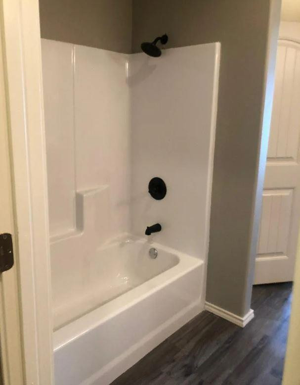 1203 Preston Trail, Unit B Wolfforth, TX 79382 - Photo 12 of 13 a bathroom with a bathtub