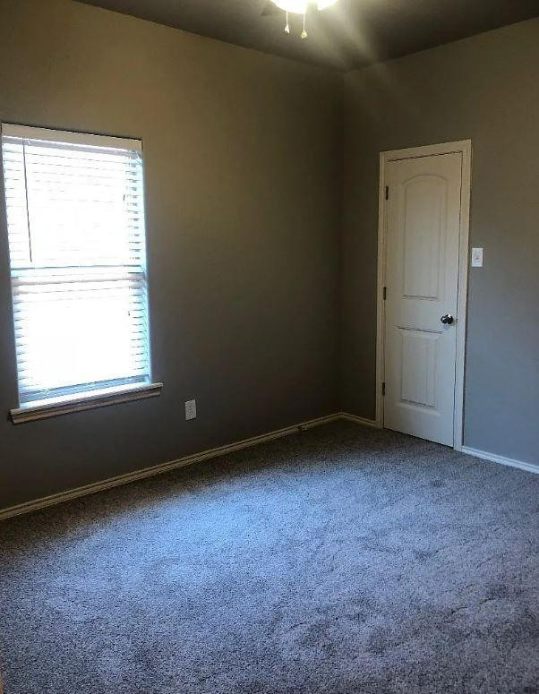 1203 Preston Trail, Unit B Wolfforth, TX 79382 - Photo 8 of 13 an empty room with a window