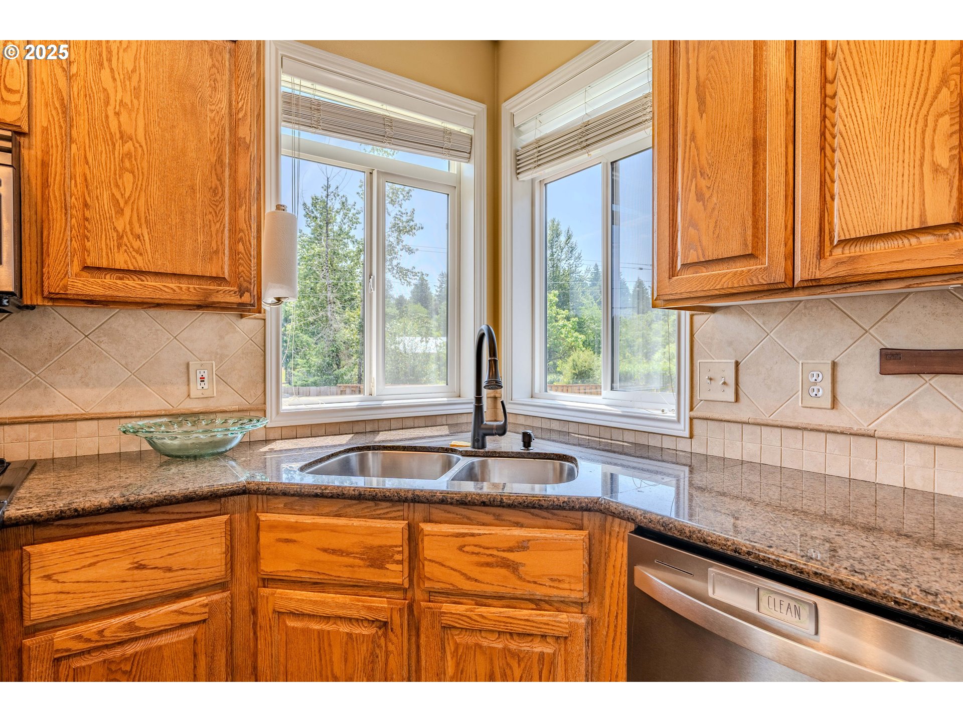 308 Southwest 38th Loop Gresham, OR 97080 - Photo 11 of 48 a kitchen with granite countertop sink and large window