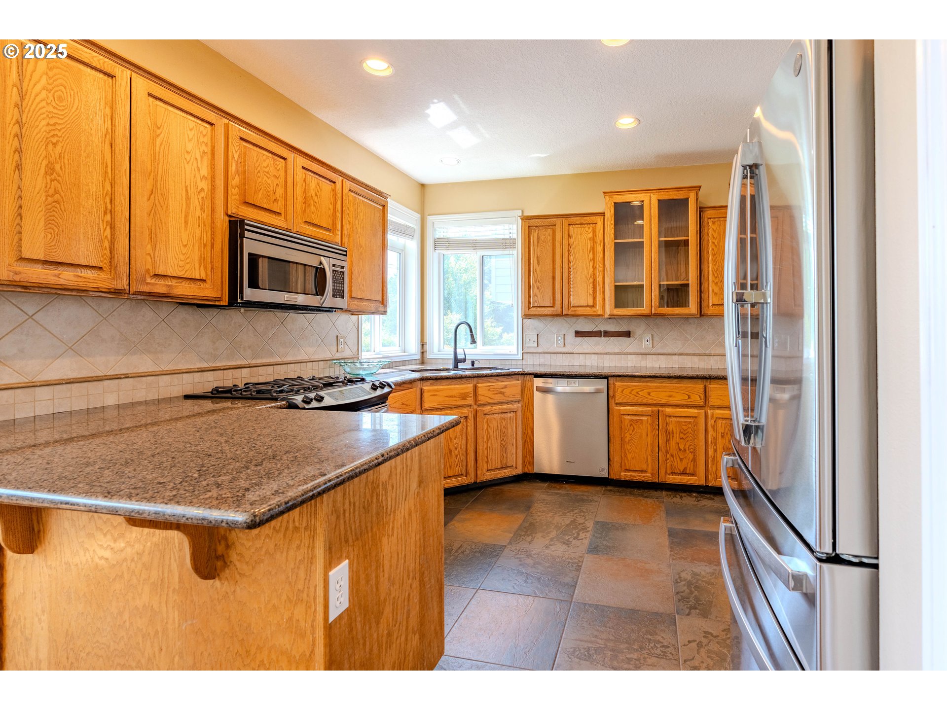 308 Southwest 38th Loop Gresham, OR 97080 - Photo 12 of 48 a kitchen with stainless steel appliances granite countertop a sink stove and microwave
