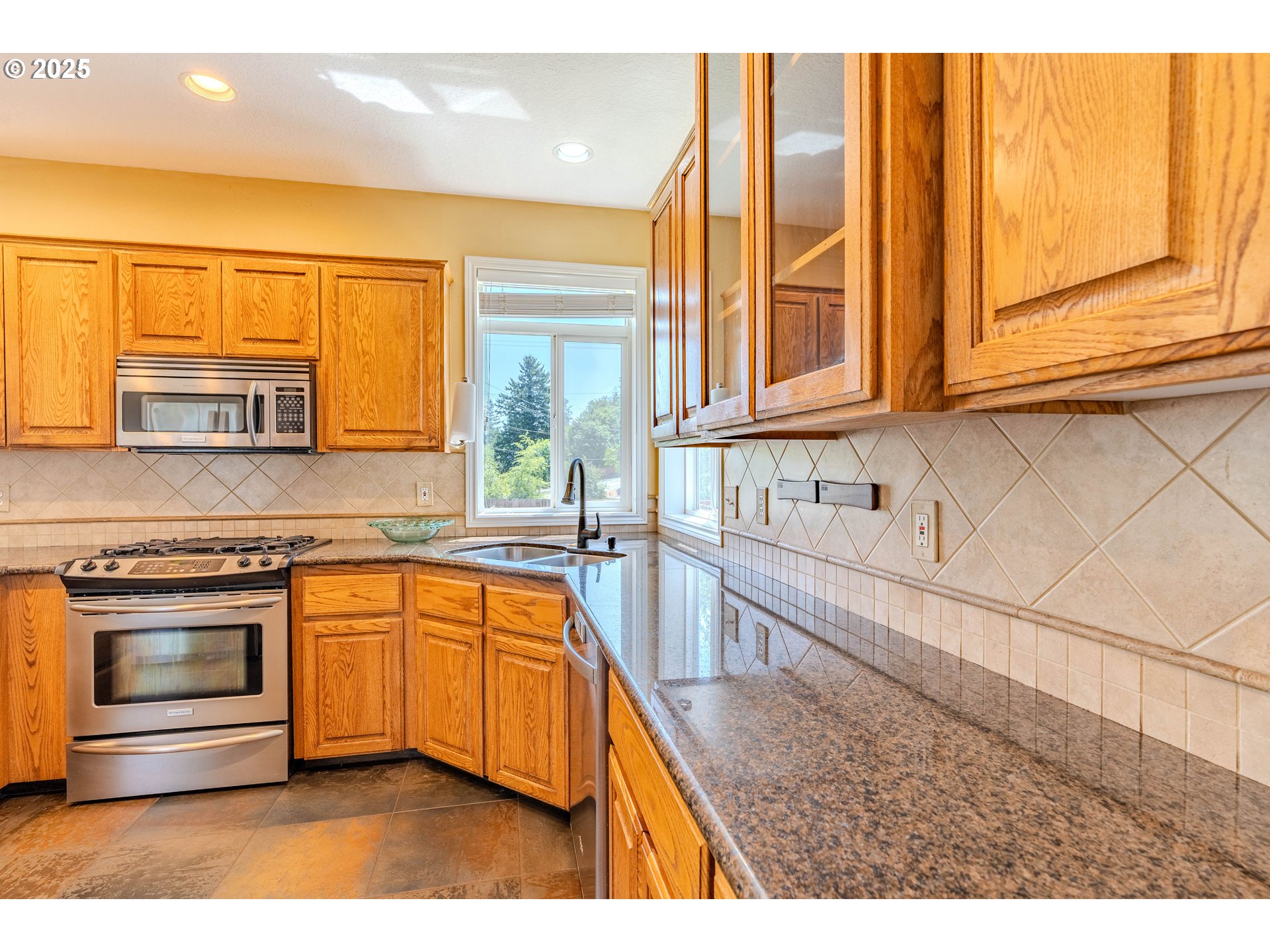 308 Southwest 38th Loop Gresham, OR 97080 - Photo 13 of 48 a kitchen with stainless steel appliances granite countertop a sink and a stove