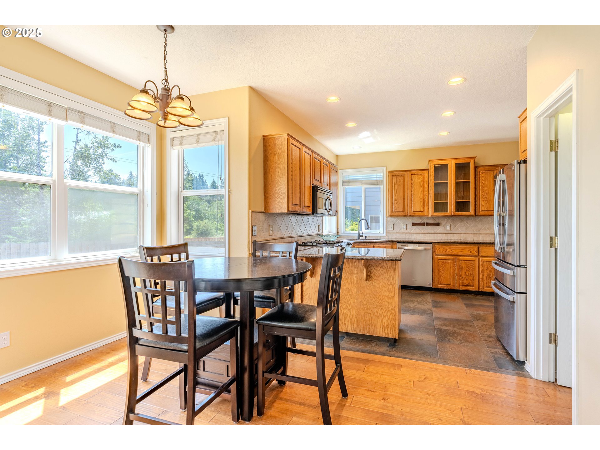 308 Southwest 38th Loop Gresham, OR 97080 - Photo 16 of 48 a view of a dining room with furniture window and wooden floor