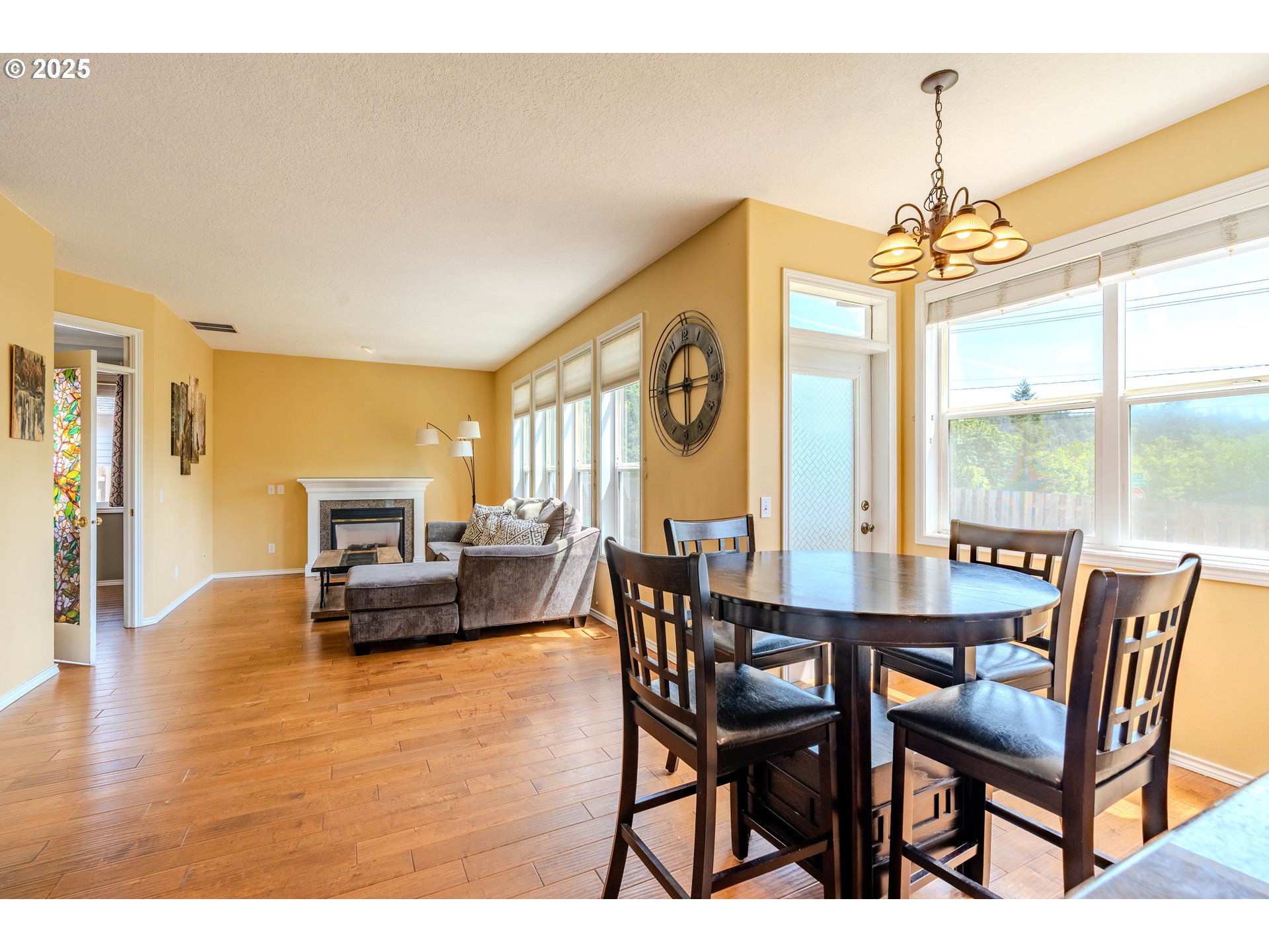 308 Southwest 38th Loop Gresham, OR 97080 - Photo 17 of 48 a dining room with furniture a chandelier and wooden floor
