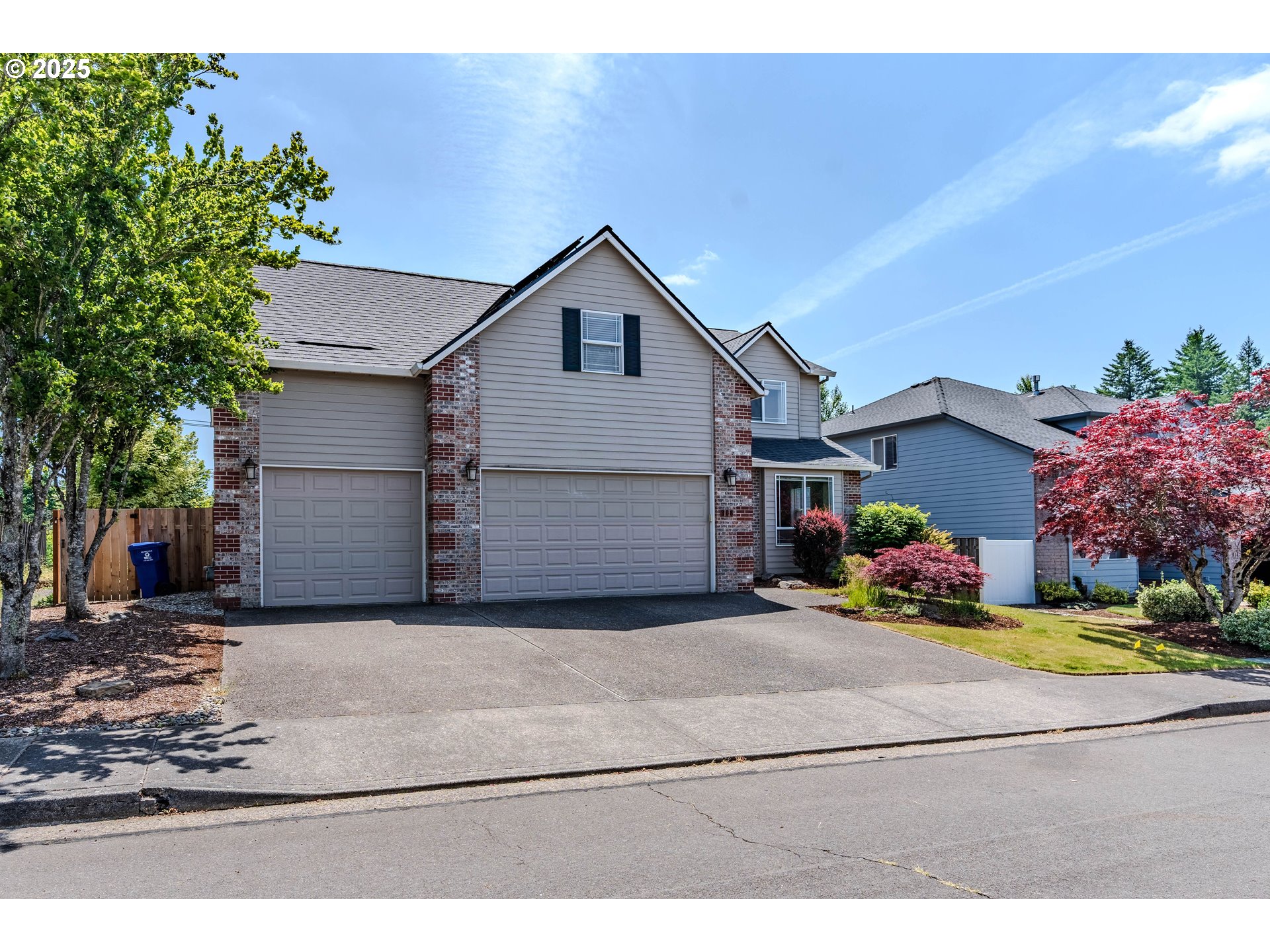 308 Southwest 38th Loop Gresham, OR 97080 - Photo 2 of 48 a front view of a house with a yard and garage