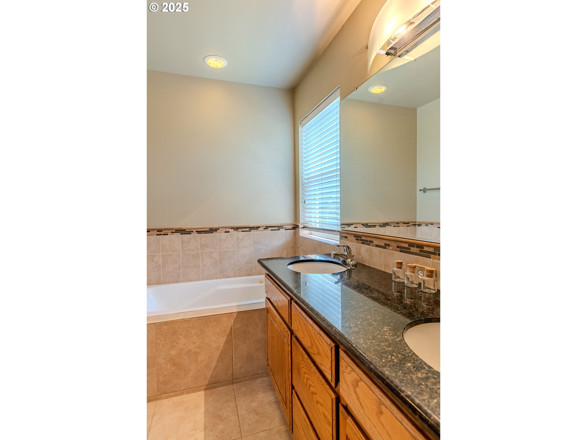 308 Southwest 38th Loop Gresham, OR 97080 - Photo 32 of 48 a bathroom with a sink a granite counter and a bathtub