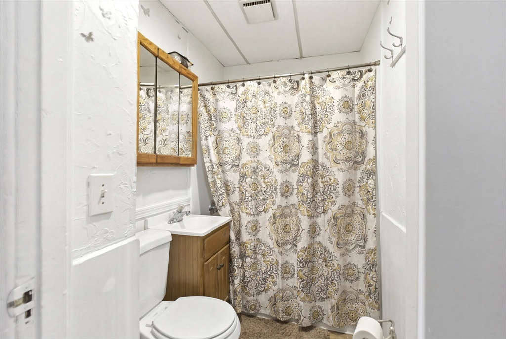 81 Ward Street Worcester, MA 01610 - Photo 16 of 34 a white toilet sitting next to a bathroom sink