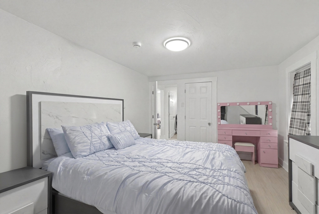 81 Ward Street Worcester, MA 01610 - Photo 21 of 34 a bedroom with a bed and a flat screen tv
