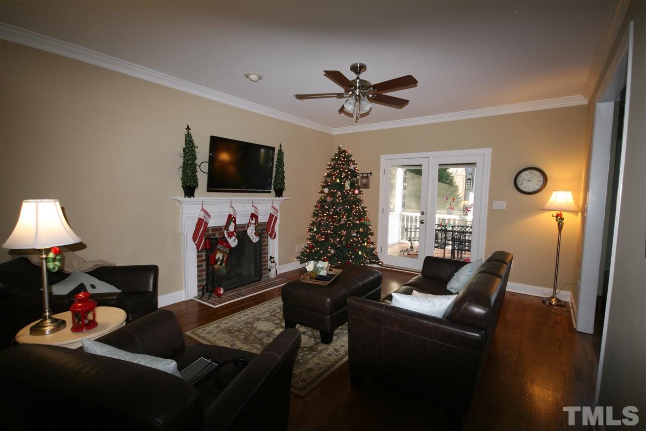 10001 Kilnstone Lane Raleigh, NC 27613 - Photo 4 of 9 a living room with furniture and a flat screen tv
