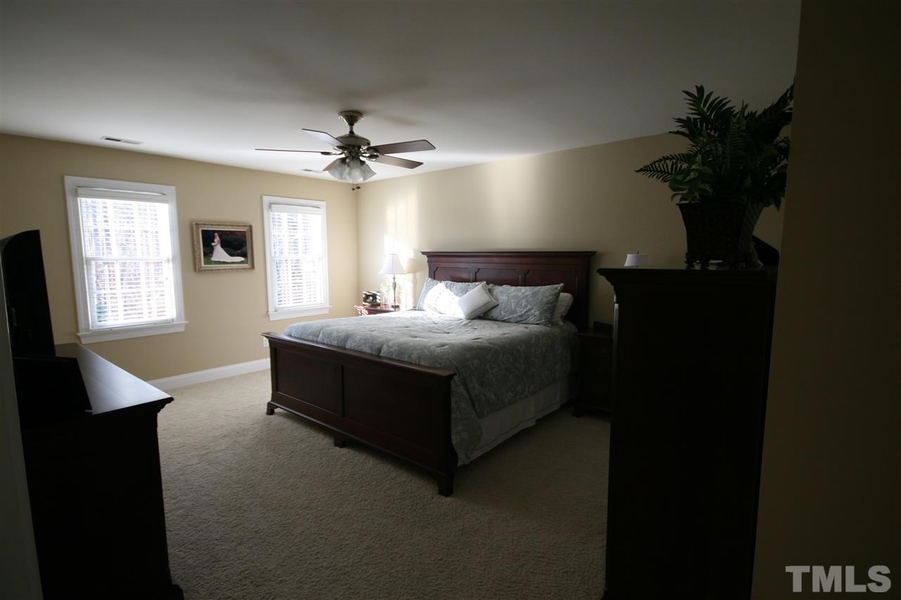 10001 Kilnstone Lane Raleigh, NC 27613 - Photo 5 of 9 a bed room with a bed window and potted plant