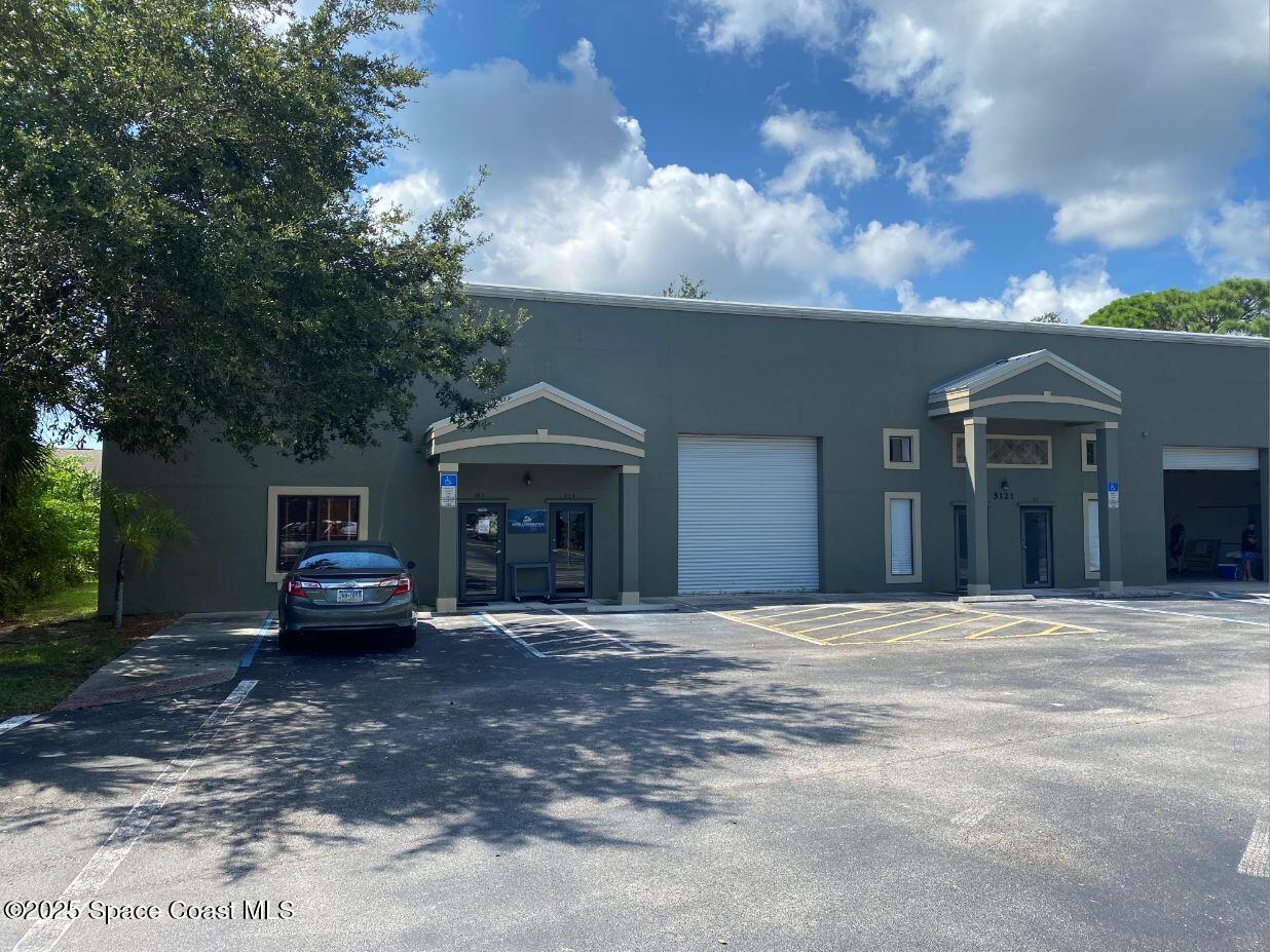 5121 Industry Drive, Unit 103105 Melbourne, FL 32940 - Photo 12 of 13 a car parked in front of a house