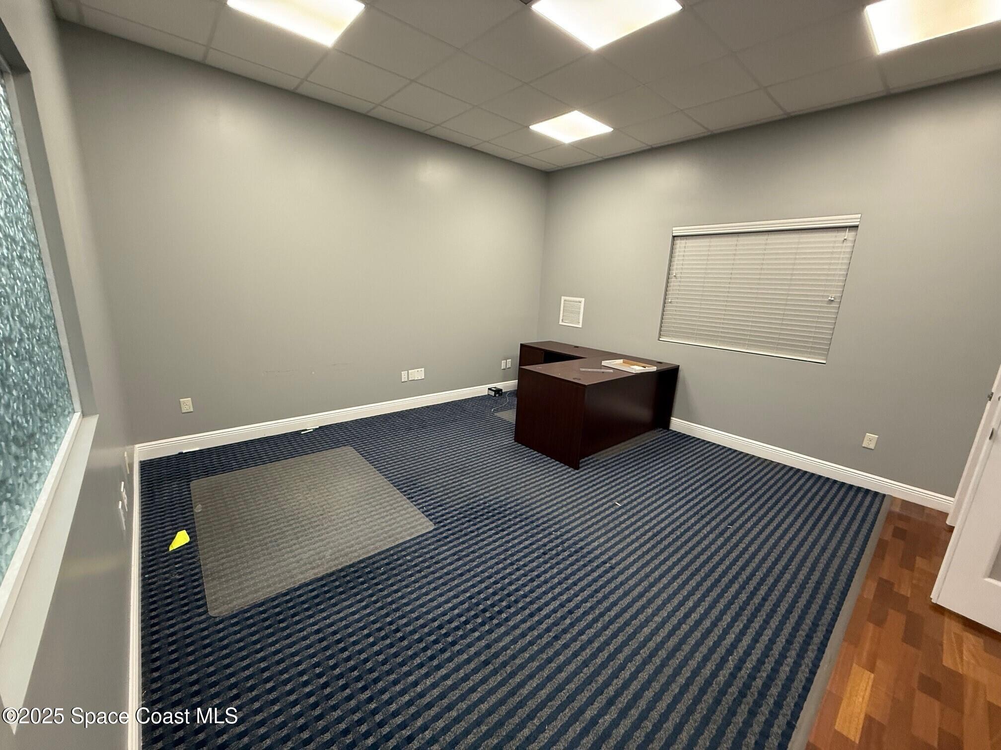 5121 Industry Drive, Unit 103105 Melbourne, FL 32940 - Photo 5 of 13 a room with wooden floor and furniture