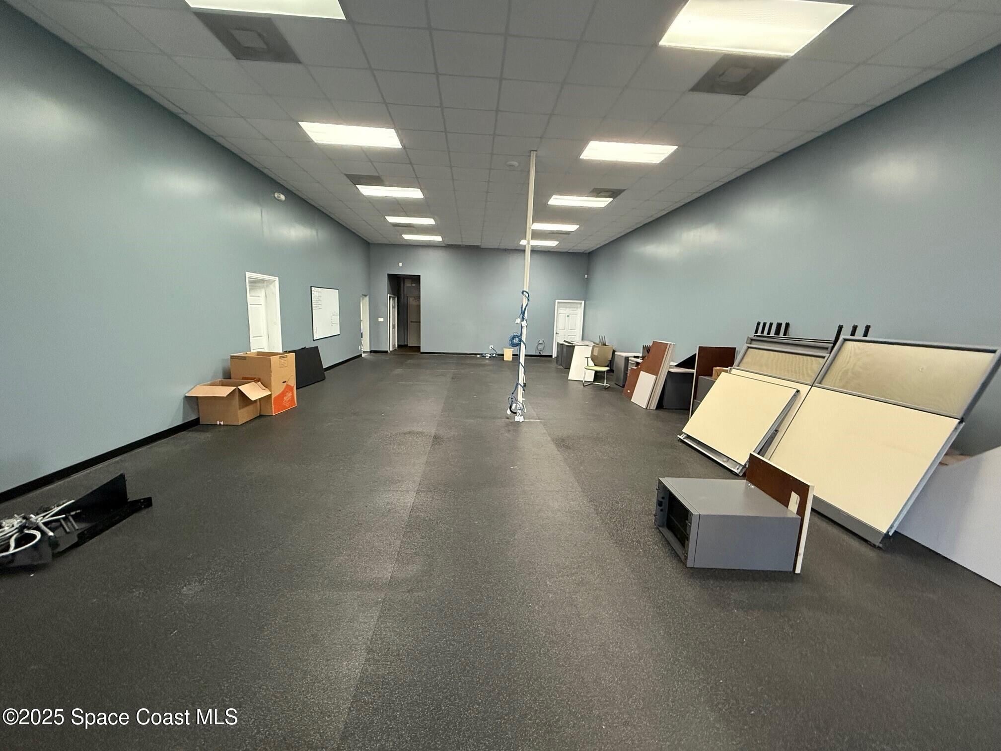 5121 Industry Drive, Unit 103105 Melbourne, FL 32940 - Photo 7 of 13 a room with gym equipment and a view of living room