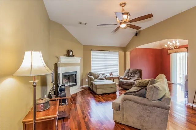 a living room with furniture a fireplace and a chandelier