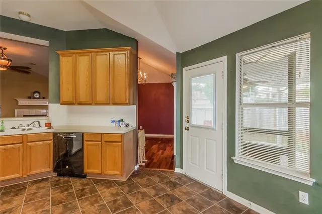 a view of a kitchen with wooden floor and electronic appliances