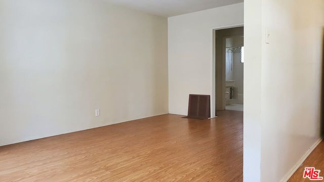 a view of an empty room and wooden floor