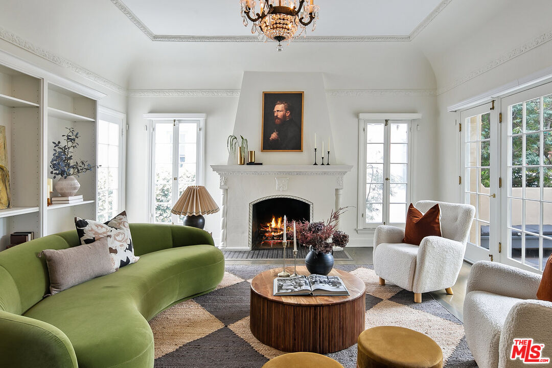 a living room with furniture a fireplace and a large window