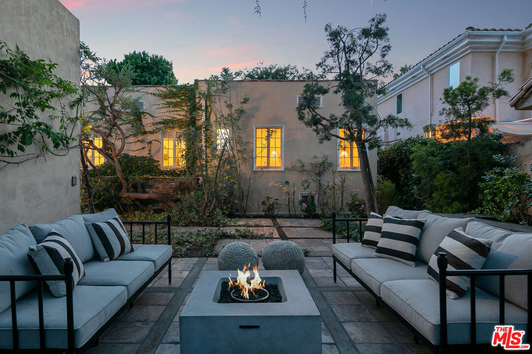 232 North Windsor Boulevard Los Angeles, CA 90004 - Photo 18 of 20 a view of a patio with couches table and chairs and potted plants
