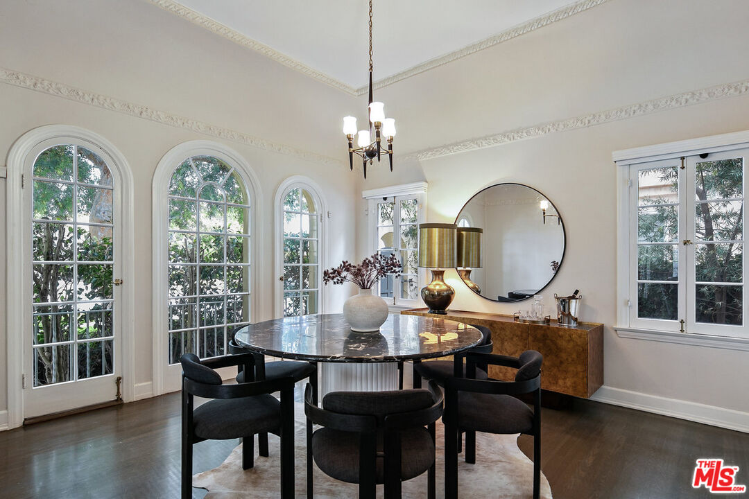 232 North Windsor Boulevard Los Angeles, CA 90004 - Photo 4 of 20 a dining room with furniture a chandelier and wooden floor