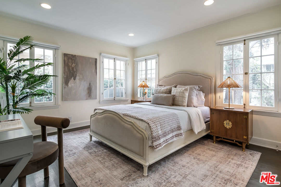 232 North Windsor Boulevard Los Angeles, CA 90004 - Photo 9 of 20 a spacious bedroom with a bed and a chandelier