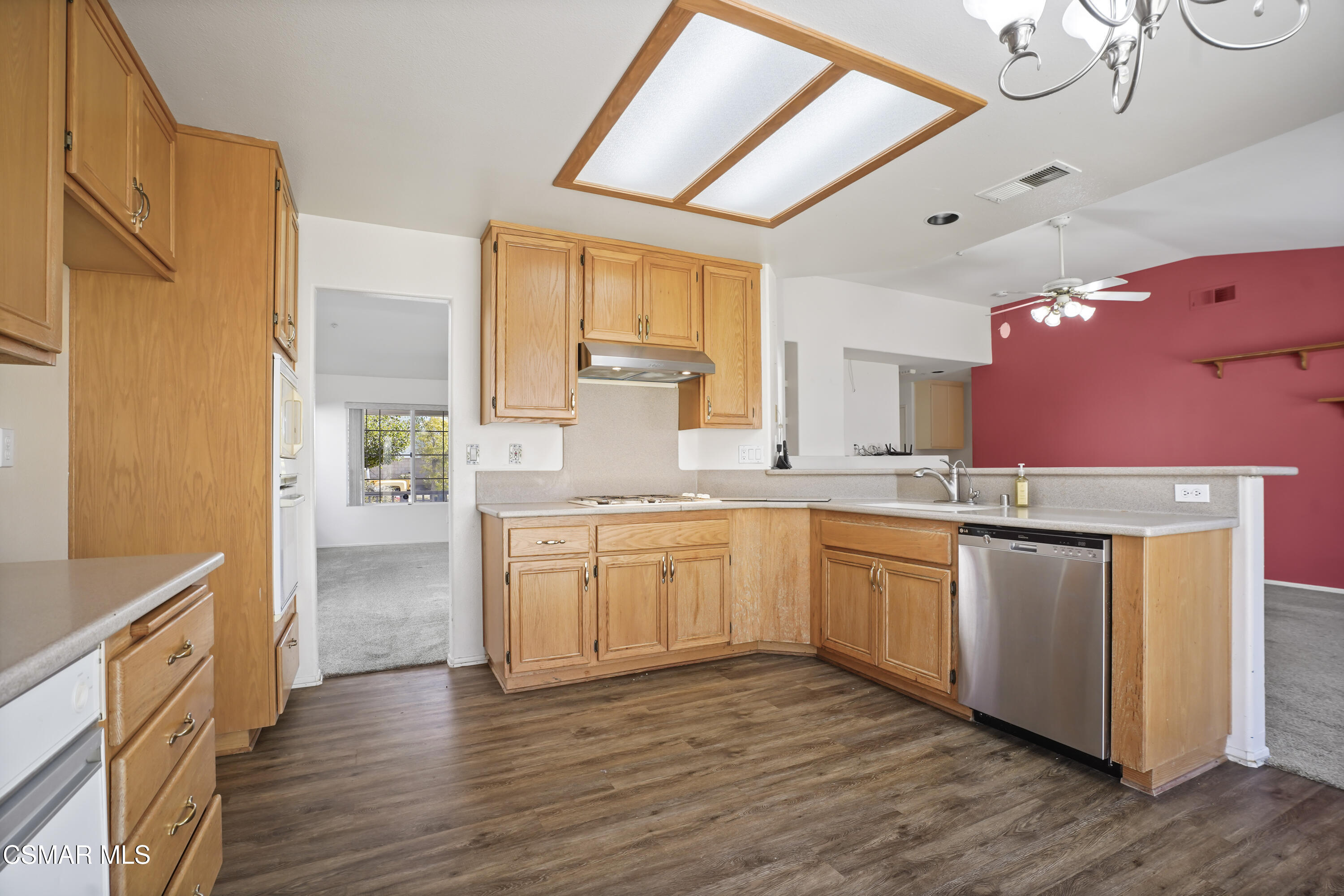 663 Novato Drive Oxnard, CA 93035 - Photo 13 of 40 a large kitchen with granite countertop a stove a sink dishwasher and a refrigerator with wooden floor