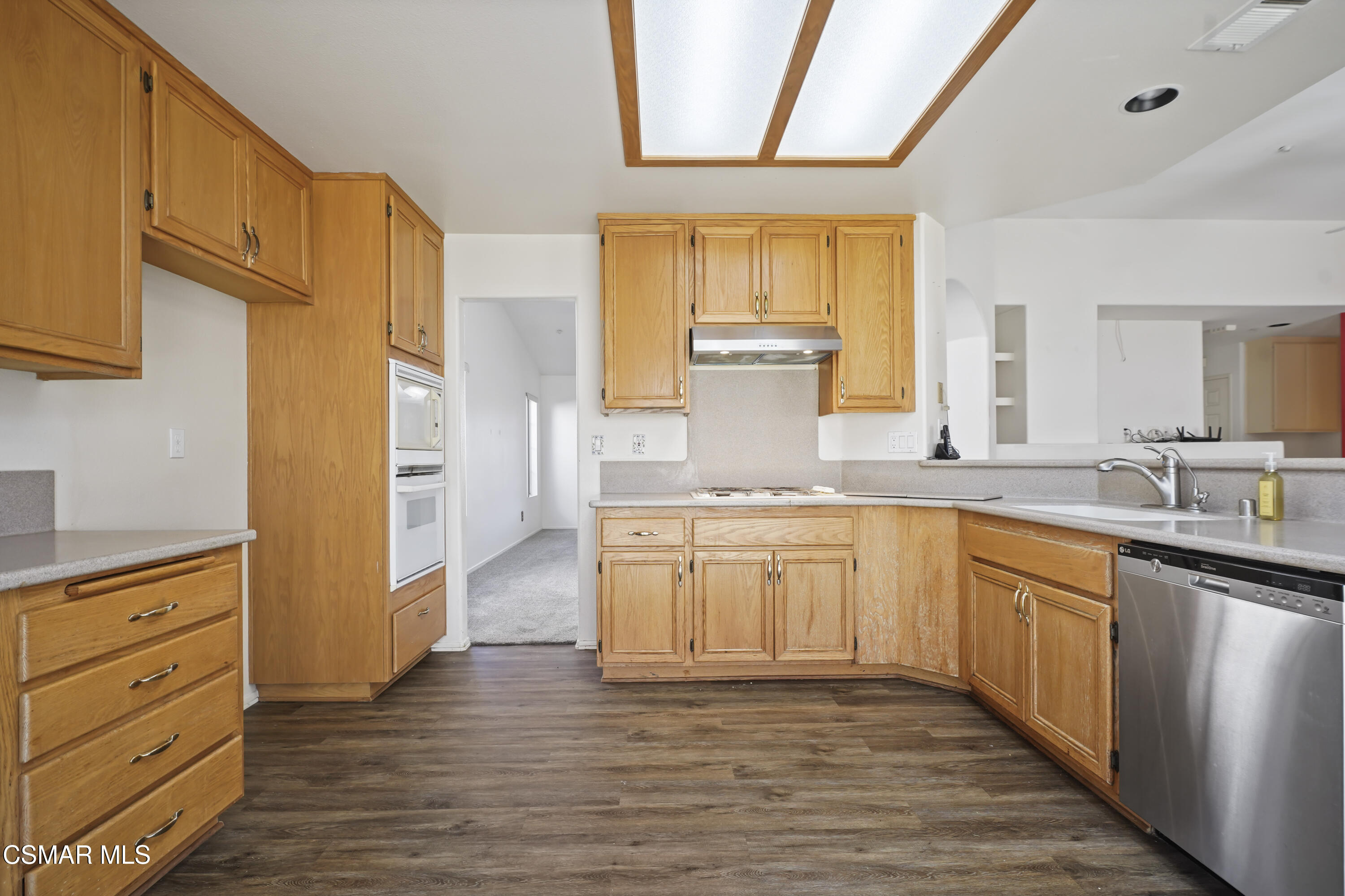 663 Novato Drive Oxnard, CA 93035 - Photo 14 of 40 a large kitchen with granite countertop a stove a sink dishwasher and a refrigerator