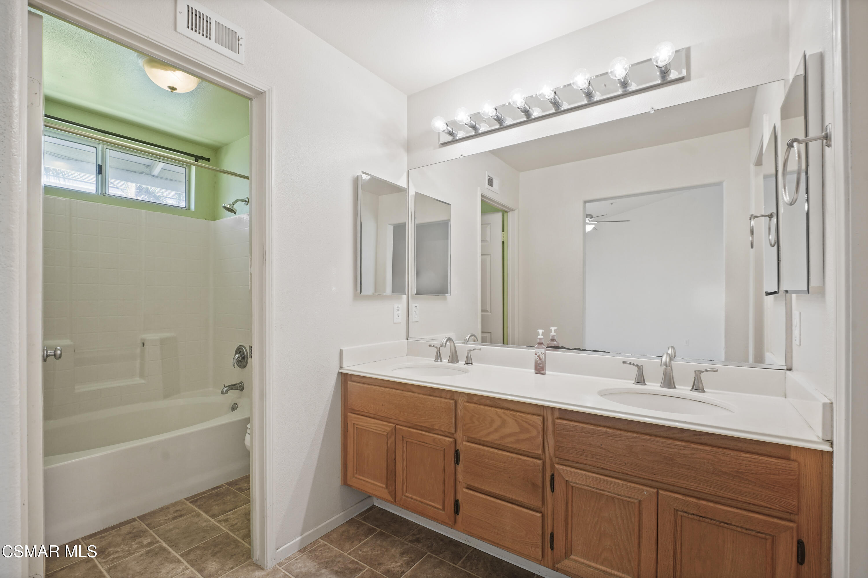 663 Novato Drive Oxnard, CA 93035 - Photo 19 of 40 a bathroom with a double vanity sink mirror and bathtub