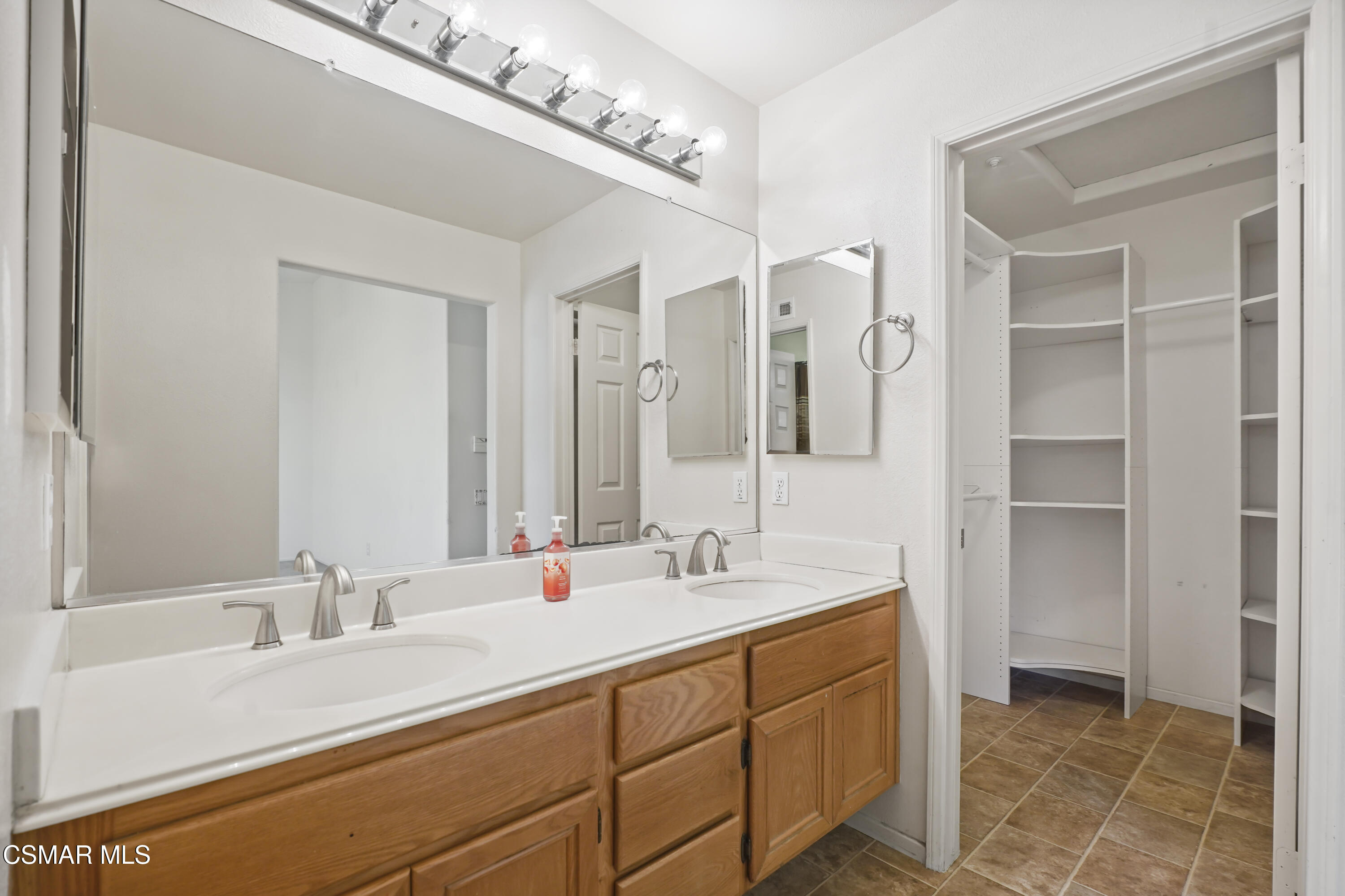 663 Novato Drive Oxnard, CA 93035 - Photo 21 of 40 a bathroom with a double vanity sink a mirror and a shower