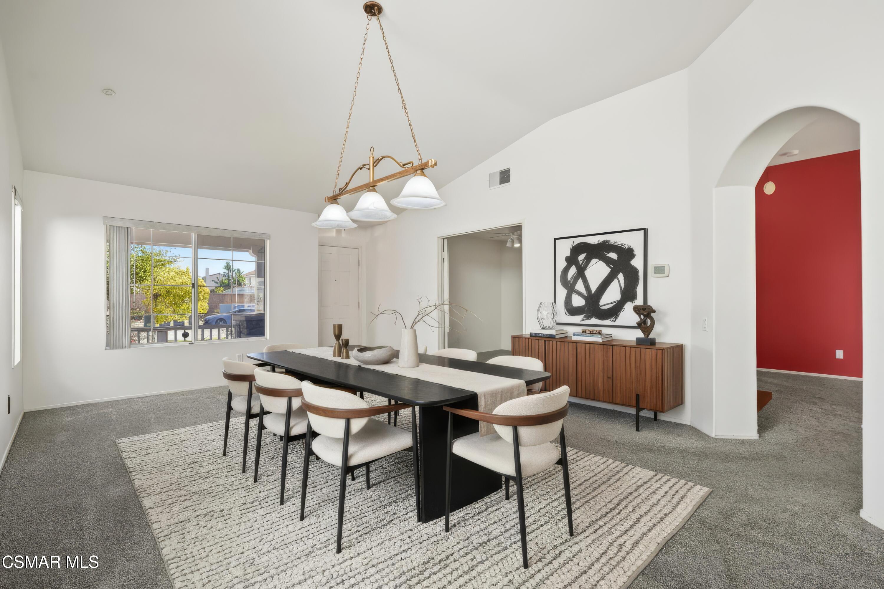 663 Novato Drive Oxnard, CA 93035 - Photo 3 of 40 a view of a dining room and livingroom with furniture wooden floor and a chandelier