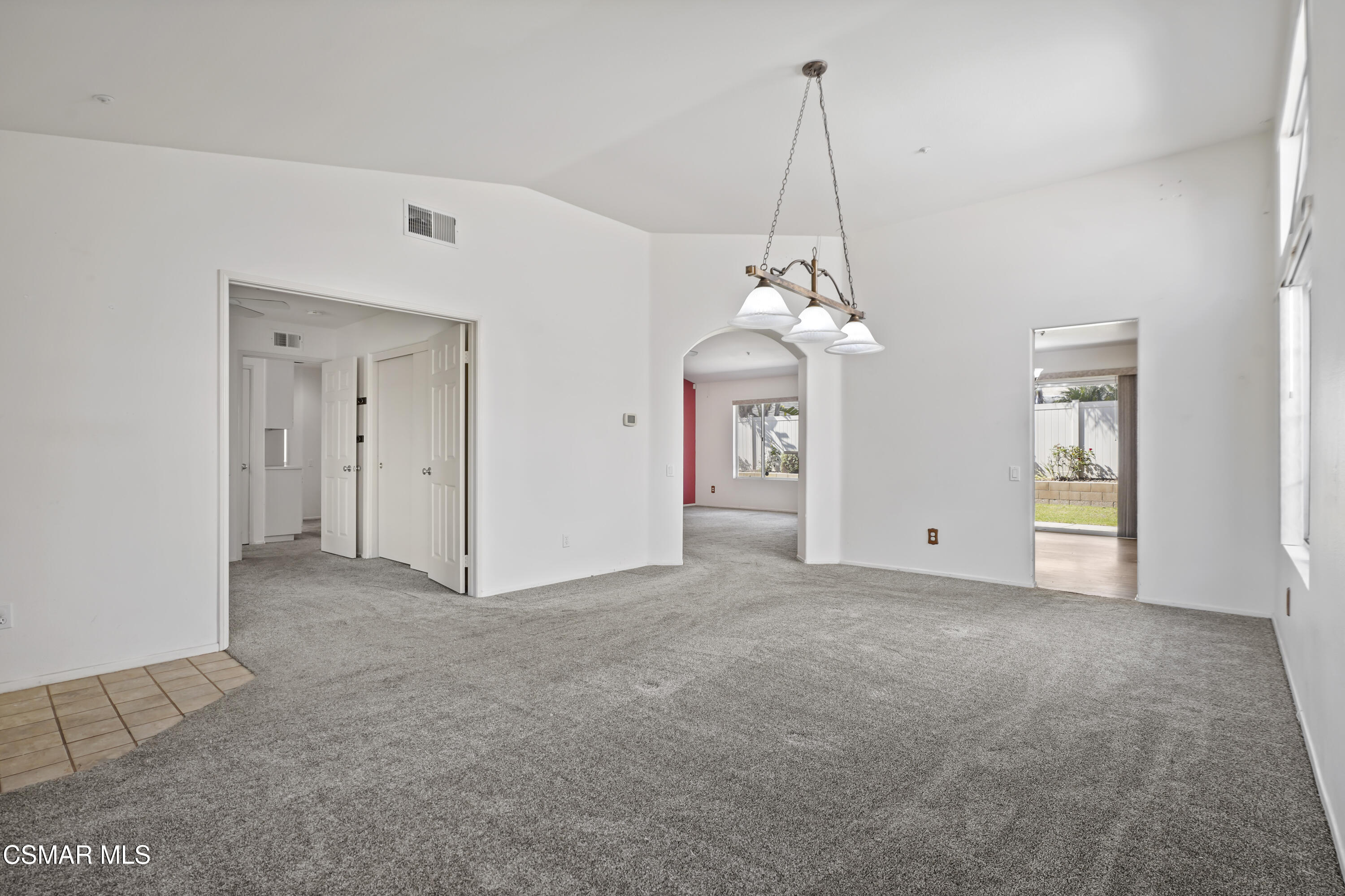 663 Novato Drive Oxnard, CA 93035 - Photo 7 of 40 a view of a room with window chandelier and glass door