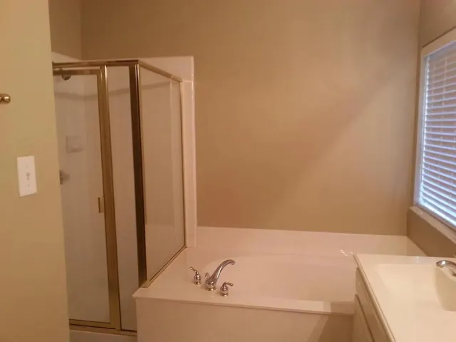 a bathroom with a bathtub and a shower